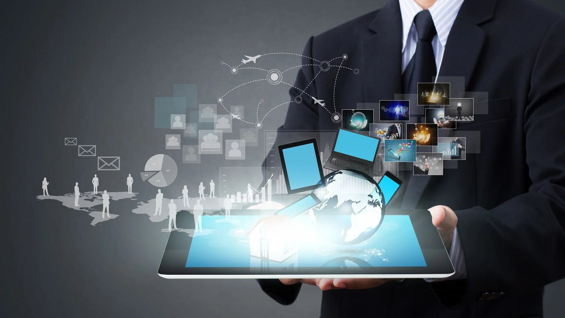 Businessman holding tablet with digital world, technology, and network icons.
