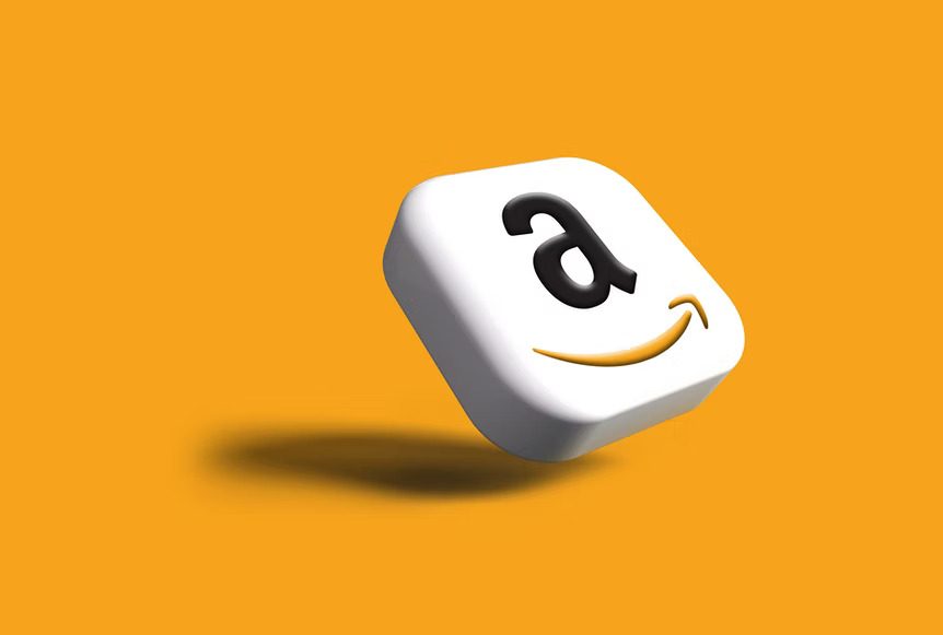 Amazon logo on a 3D cube with yellow background.