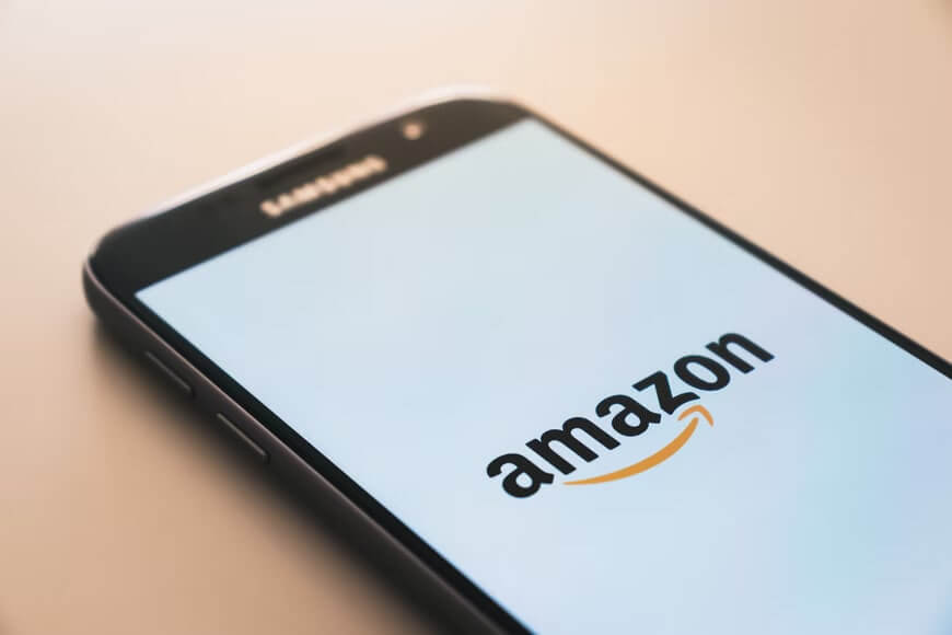 Samsung smartphone displaying Amazon logo on screen.